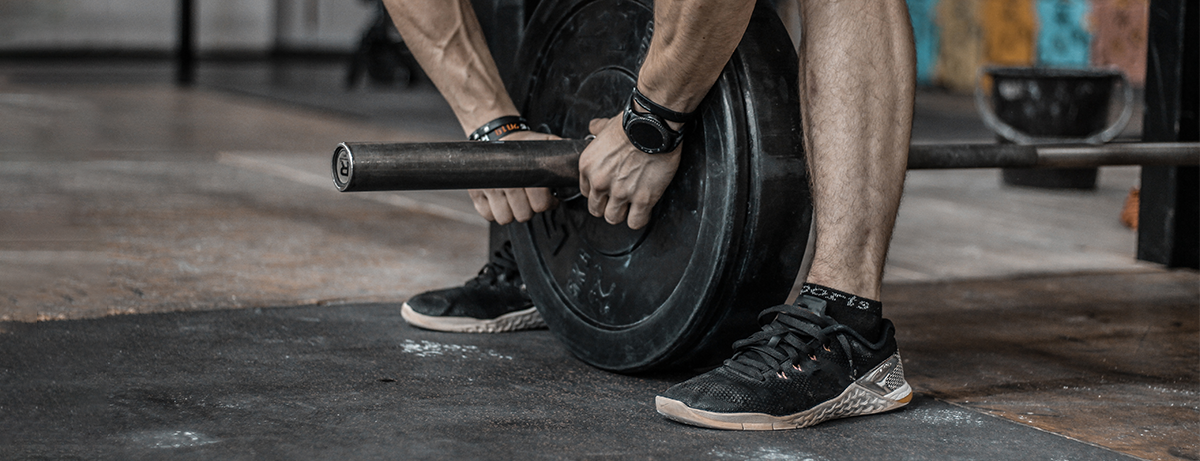 Male holding gym weights