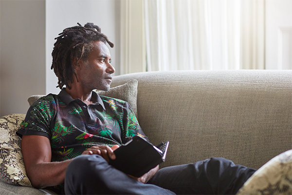Male in living room reading a book