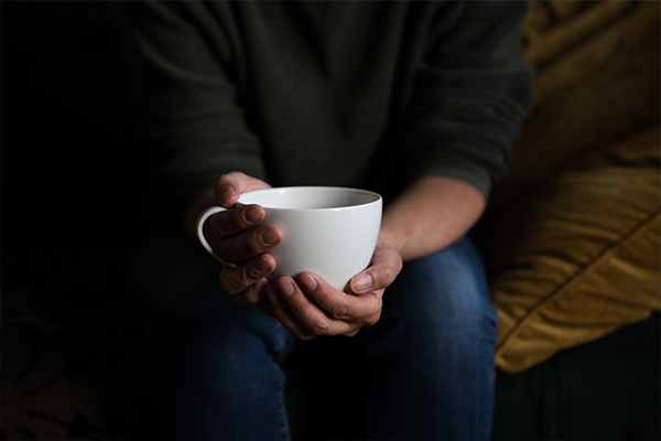 Close up of hands holding a cup