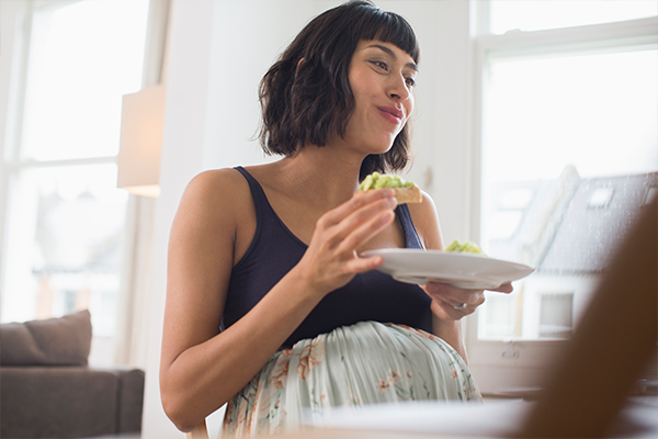 Female eating kimchi in kitchen
