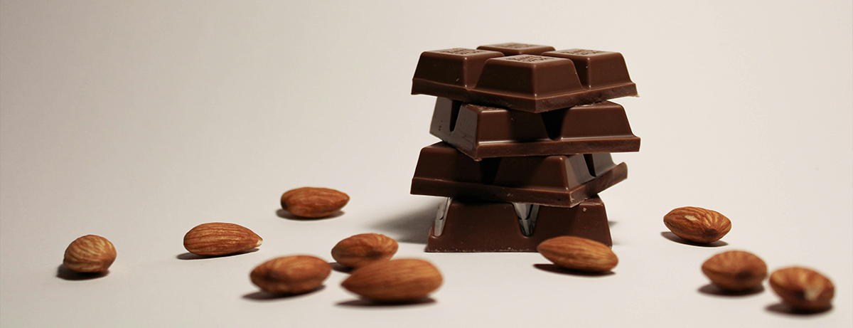 Vegan chocolate and cocoa beans on white background