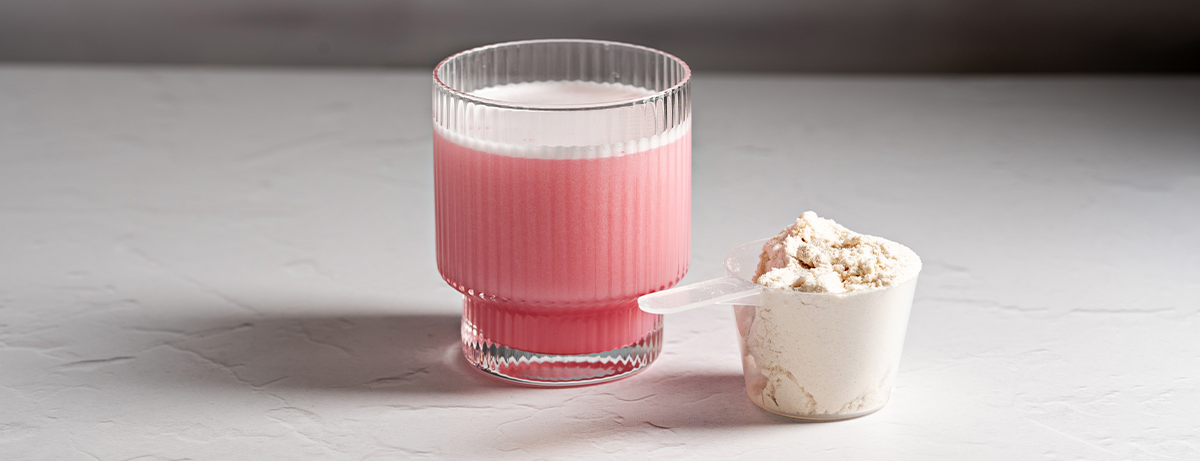 Glass with pink collagen powder inside of it