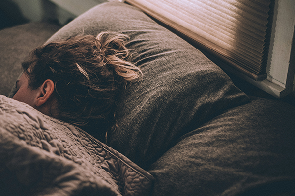 Female asleep on bed