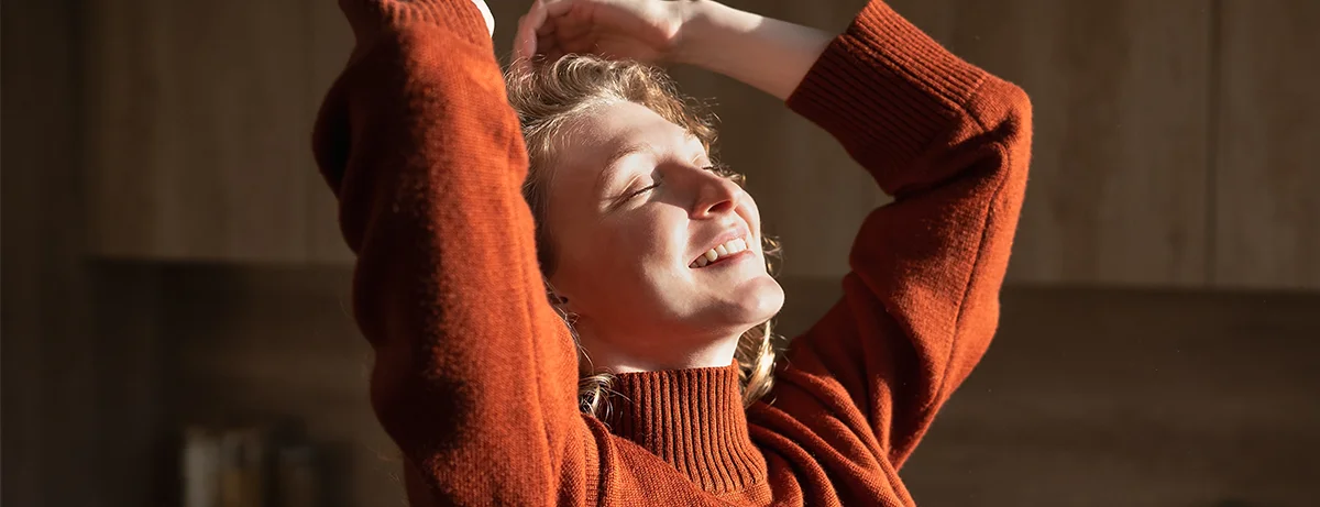 Female in red jumper with happy calm expression