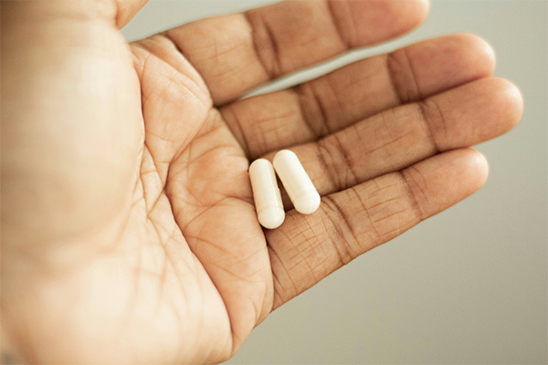 Close up of iron supplement in hand