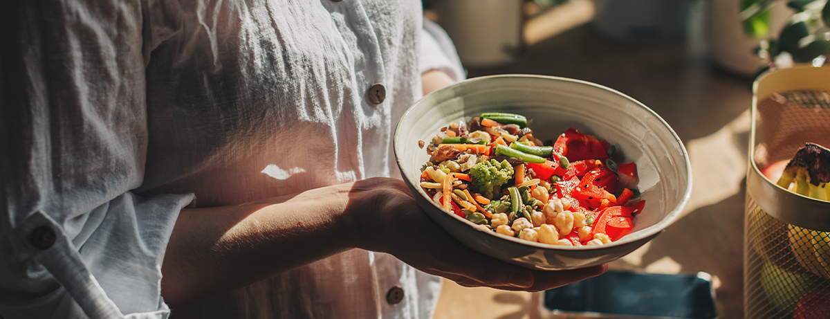 Female holding a bowl of healthy vegetables