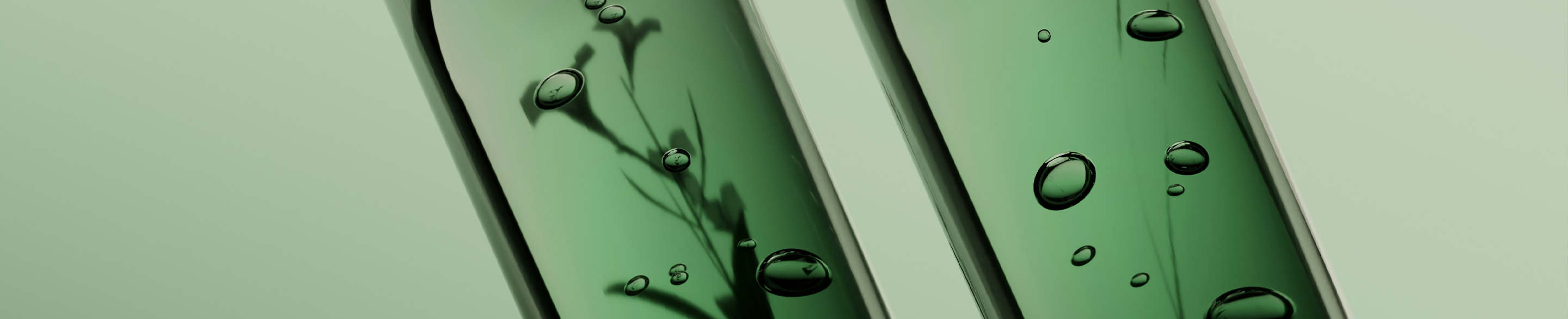 macro shot of 2 test tubes on green background