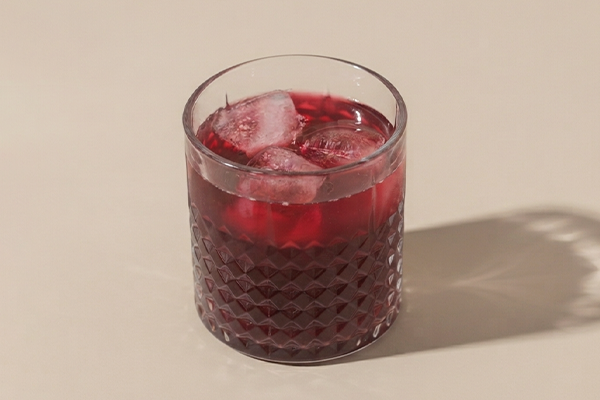 Glass of beetroot juice on a beige background
