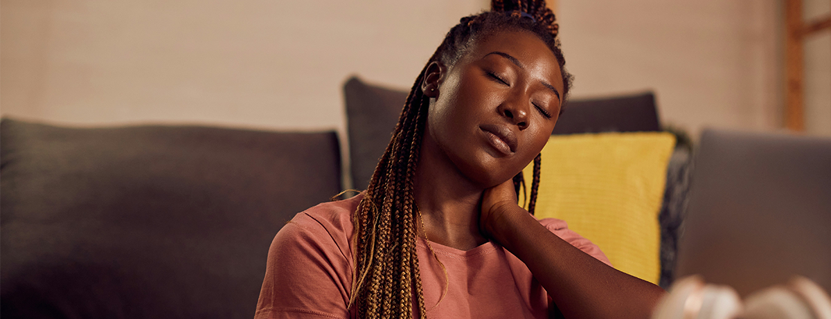 Woman at home sitting on the sofa with rested expression