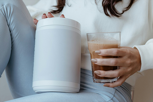 Female holding protein shake