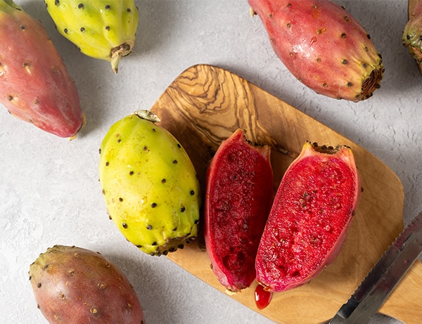 Prickly pears, exotic cactus fruits cut in halves, top view.