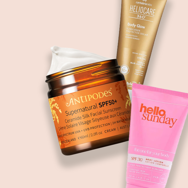 Selection of beauty products sitting on a pink background