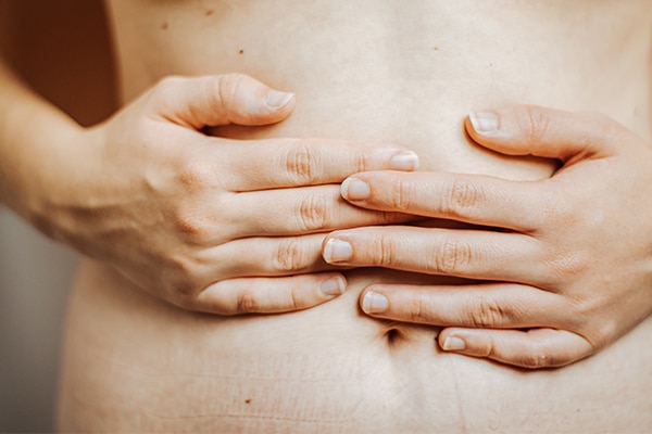 Female holding hands on stomach