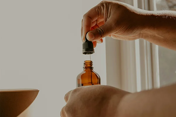 Hand opening an essential oil