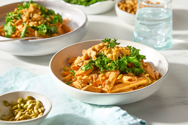 Chickpea penne pasta in white bowl