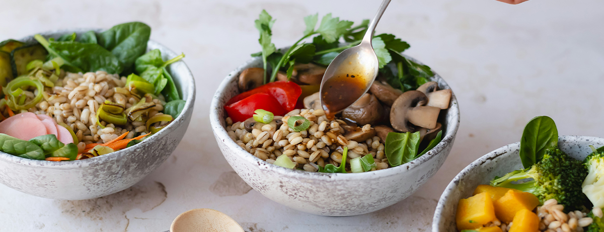 3 bowls of low fodmap foods including vegetables and grains