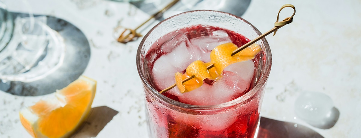 Glass of alcoholic drink on white table