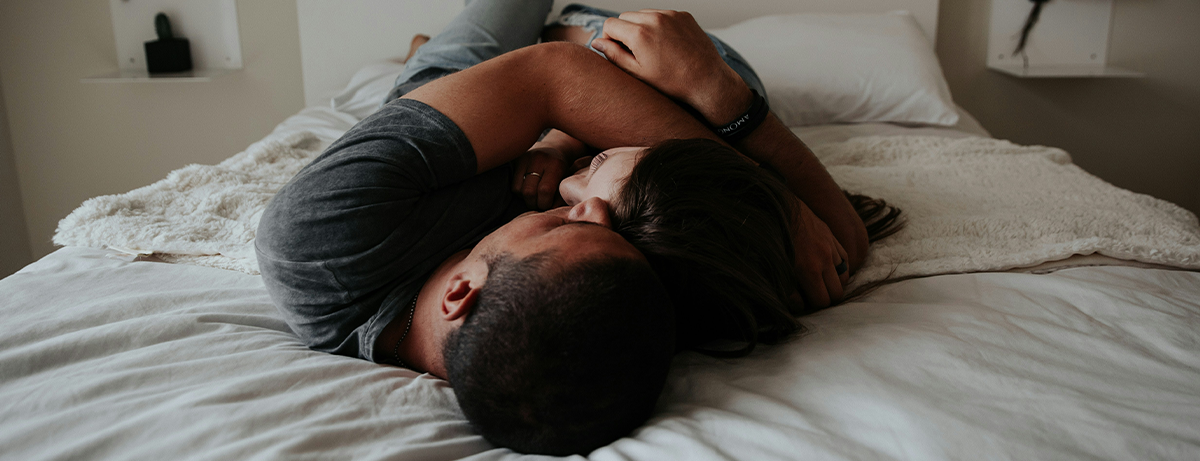 Couple cuddling in bed