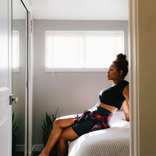 Female sitting on bed relaxing