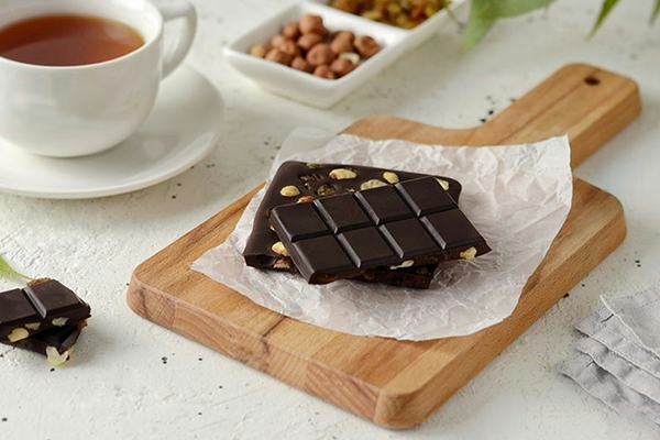 Dark chocolate on a wooden chopping board