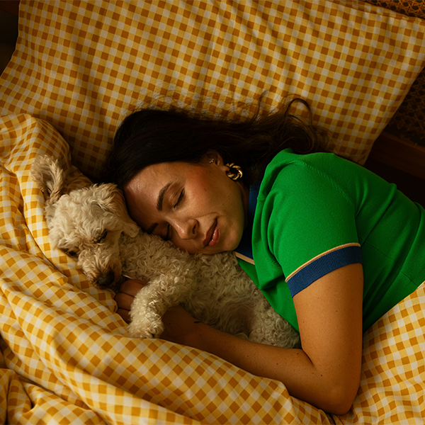 Female asleep with dog on the bed