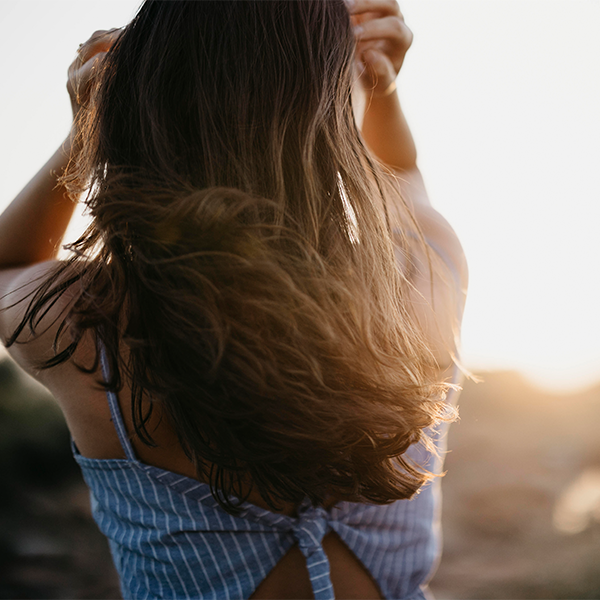 Female looking away from camera in front of sunset