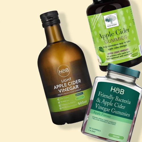Selection of apple cider vinegar products on green background
