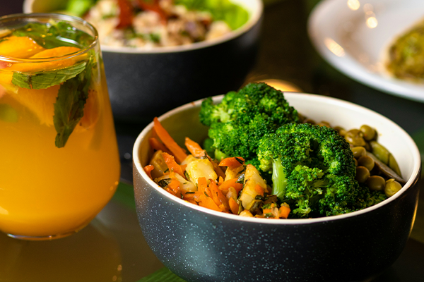 green vegetables in a black ceramic bowl