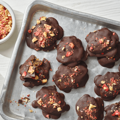 Portion of square chocolate nut puddles on a baking tray