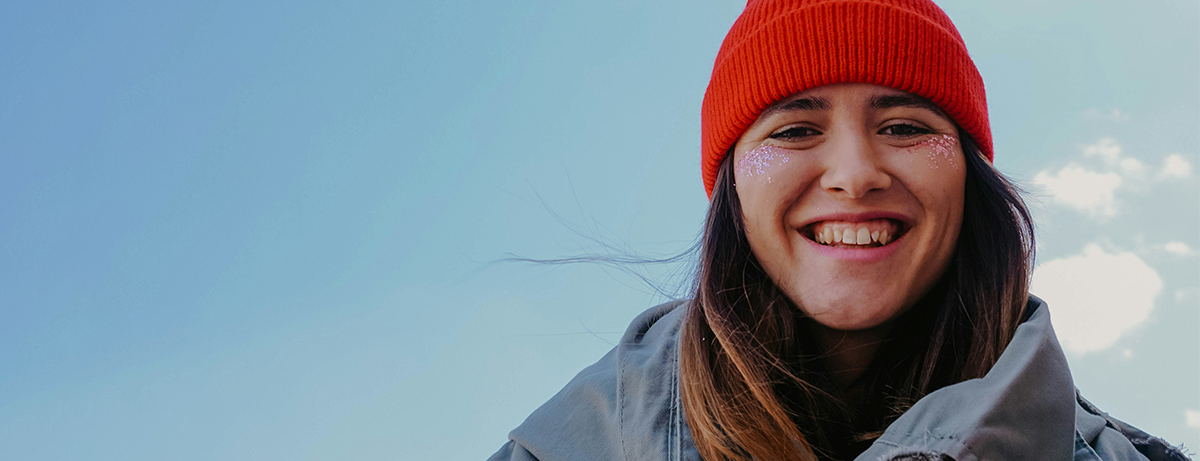 Female outdoors in the cold with red beanie hat