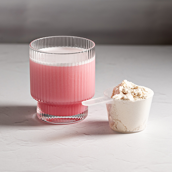 Vegan collagen in a glass with pink colouring