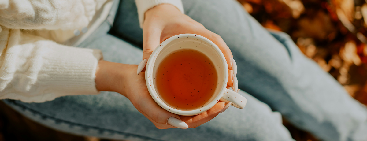 Hand holding a mug of agnus castus tea