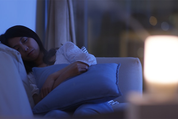 Woman sleep on sofa at night