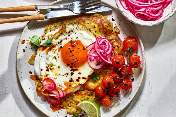Gluten free flatbread on a white plate with a fried egg