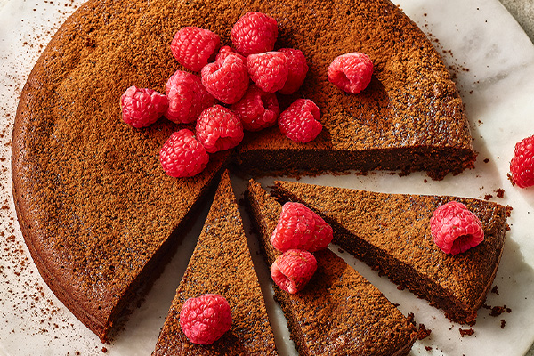 Chocolate torte on a white plate cut up into slices