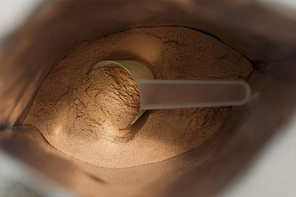 packet of collagen powder with scoop inside