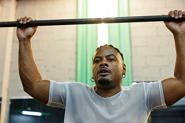 Male lifting weight bar in the gym