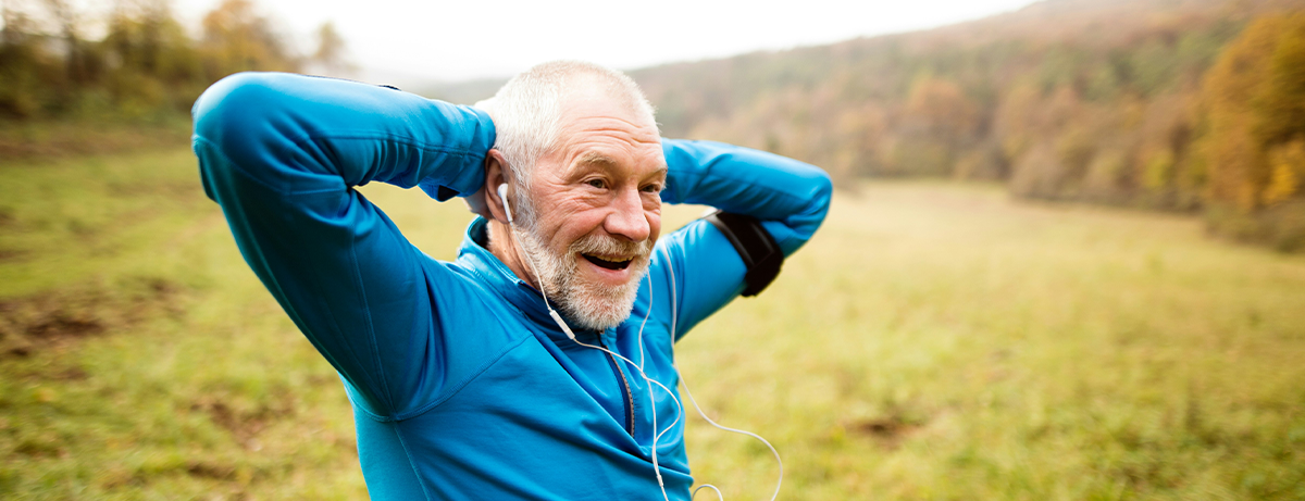 A man with blue running jacket stretching before a run