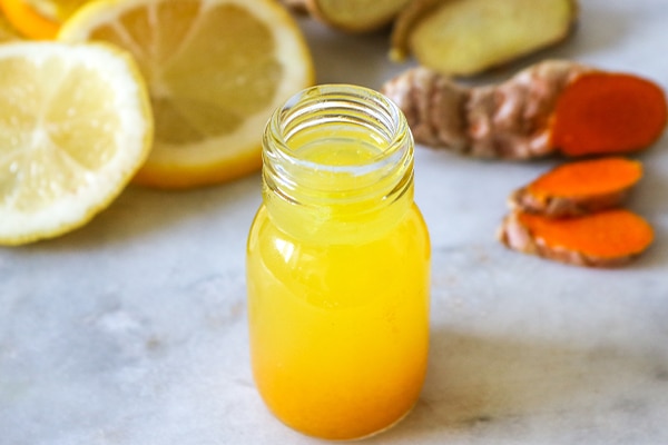 Close up of a healthy Ginger Lemon Turmeric Shot – ideal to boost the immune system during the winter.