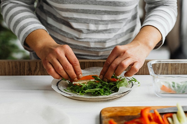 female preparing food on kitchen worktop