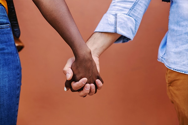 hands close up on brown wall background