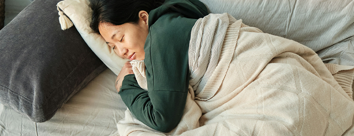 Female resting on bed with calm expression