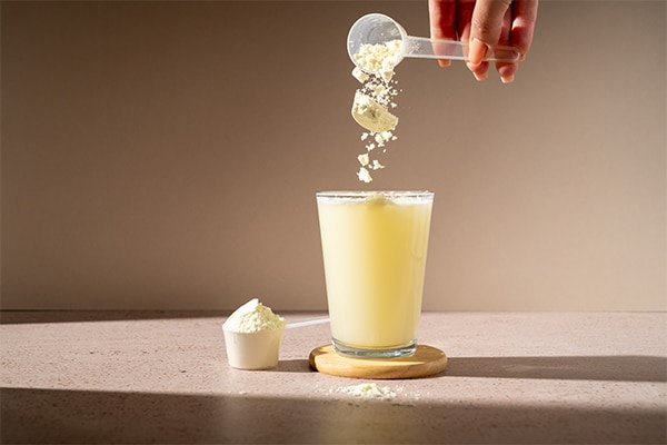 Protein shake and protein powder in a scoop, collagen, creatin, food supplement