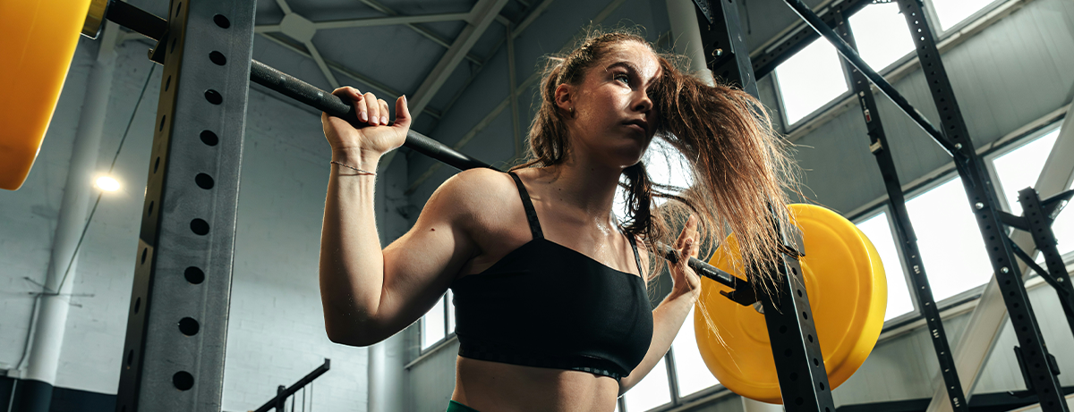 female in the gym holding bar bell