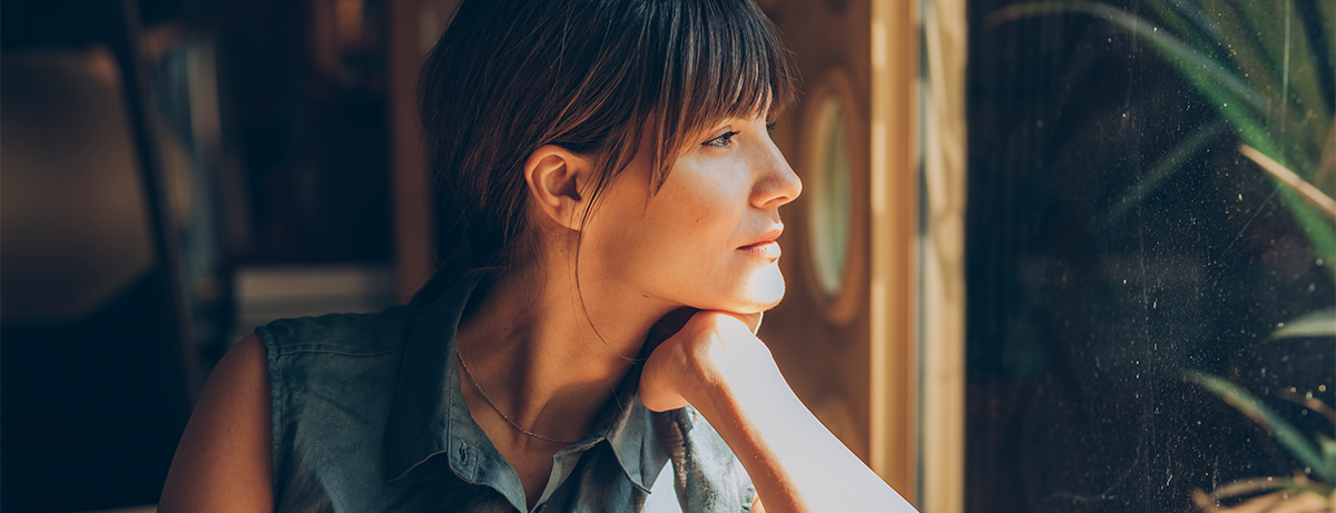 Female looking towards the window with happy expression