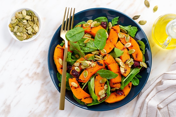 Portion of pumpkin seeds on sweet potatoes