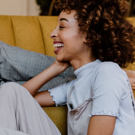 friends laughing as chatting on the sofa