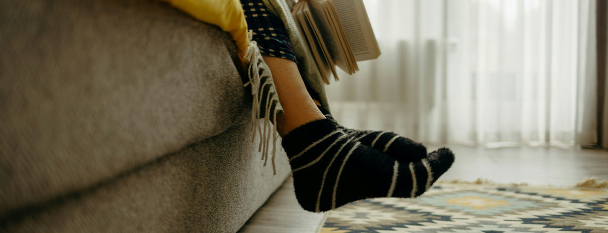 Close up of legs hanging off the sofa