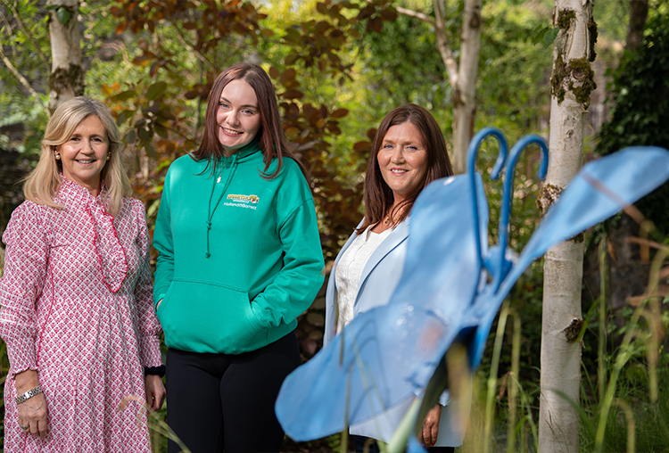 3 females standing in forest