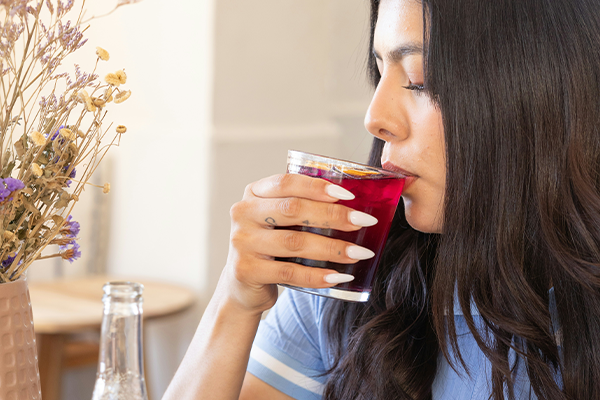 female in home drinking beetroot juice